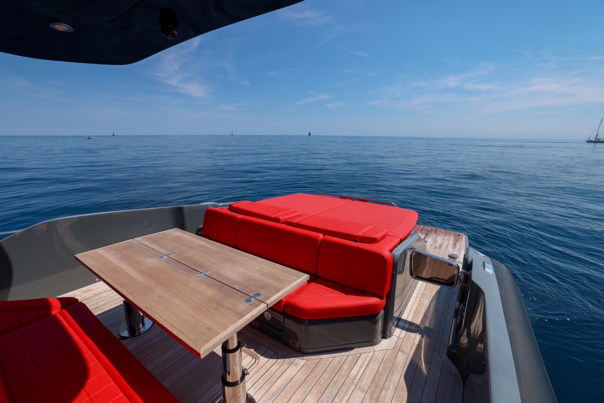 The table of Queen of Hearts on the wide open bay, a sailboat on the horizon