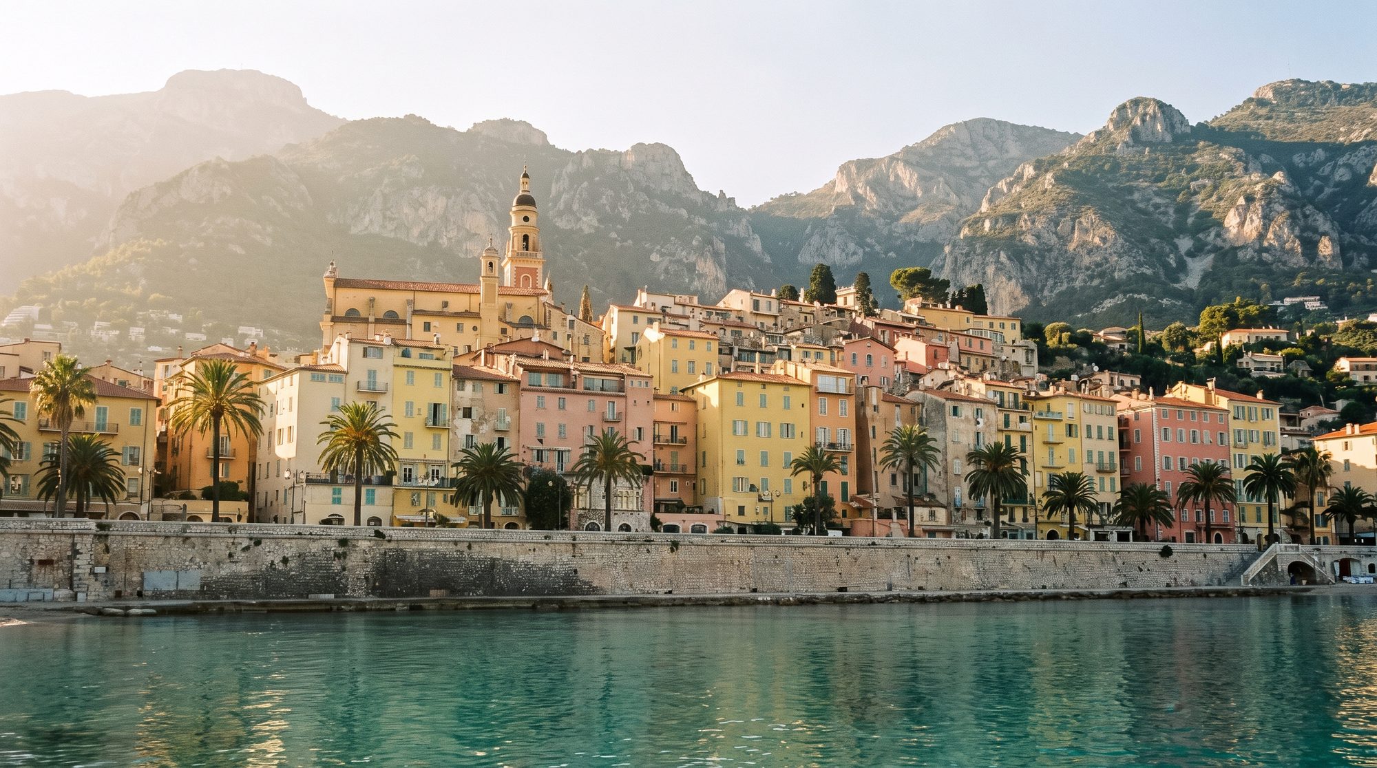 The pastel old town of Menton stacked above the sea beneath the mountains